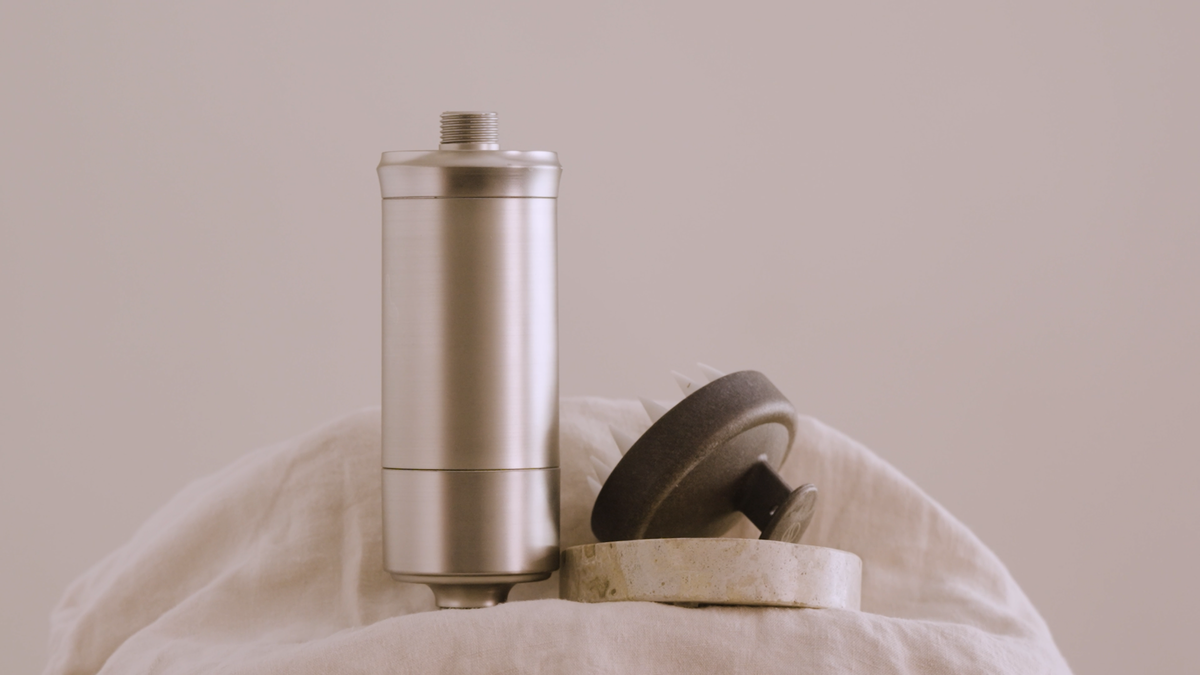 The SEDA shower filter stands next to other hair products.