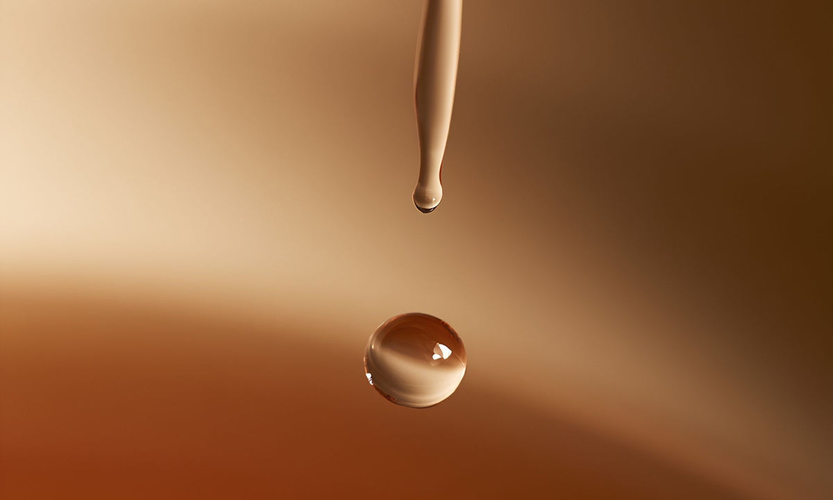 A drop of water falling over a terracota background
